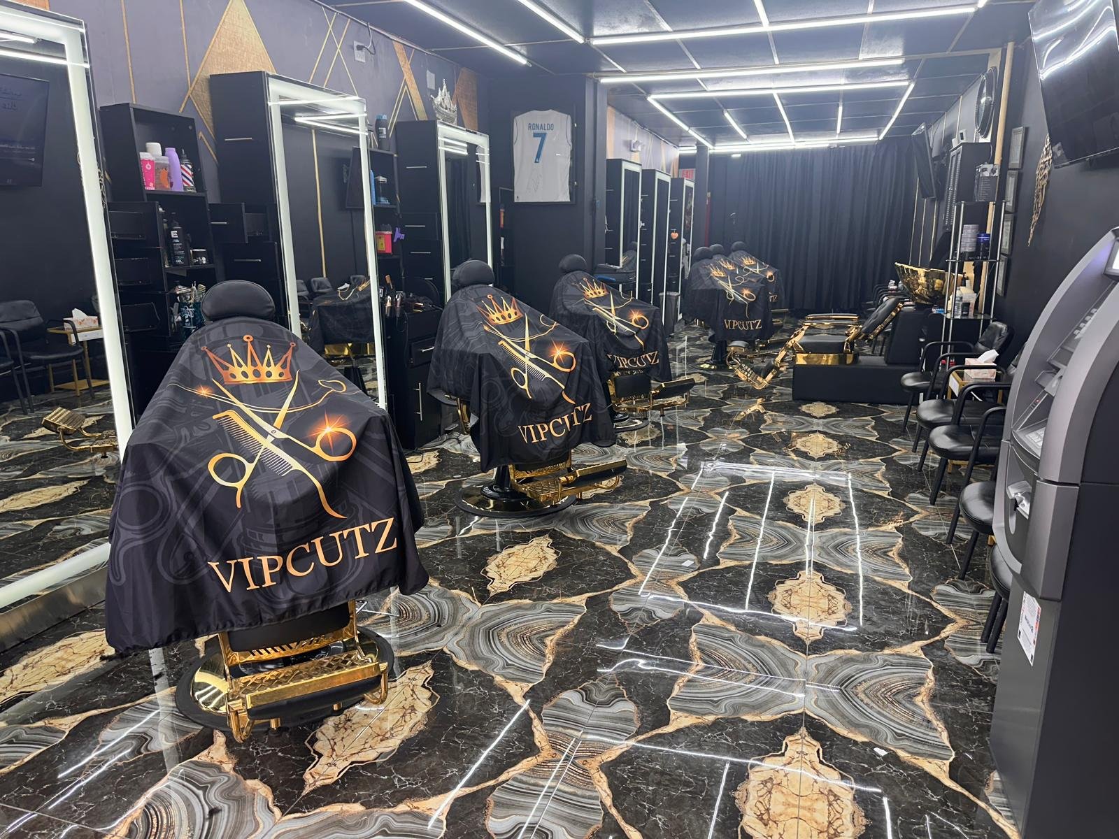 Inside V.I.P Cutz — black and gold luxury barbershop interior in Clifton, NJ